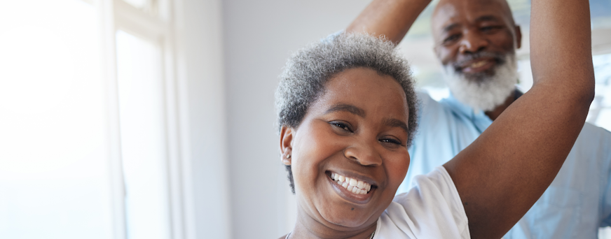 Life Assure Senior Woman Sitting In Chair And Laughing With Caregiver Nurse Hero